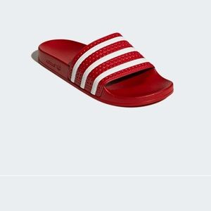 Red Adidas slides, good condition. Tag is 6M, fits a 7-7.5 women’s.